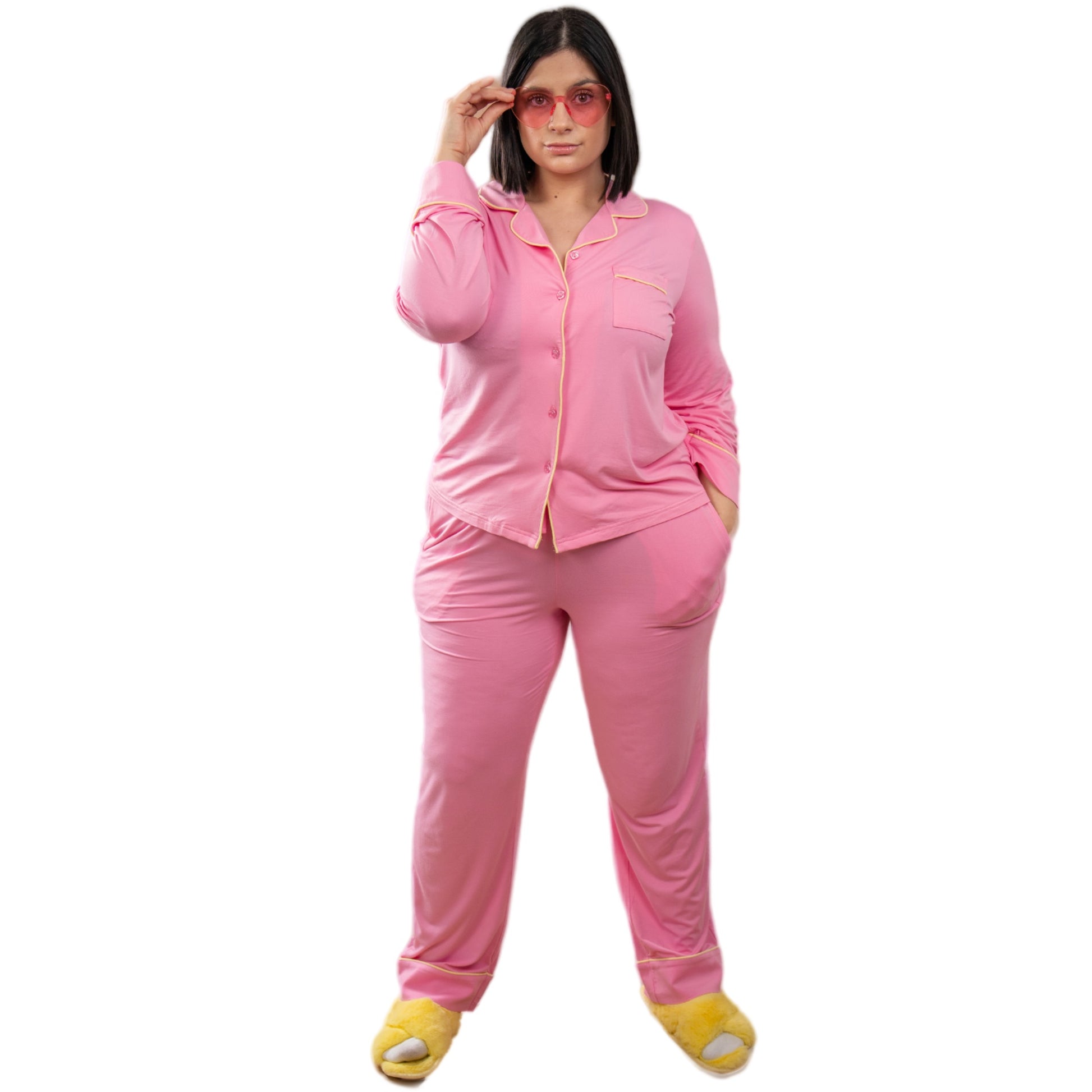 A girl wearing pink long sleeve bamboo pajama set and yellow slippers image 1