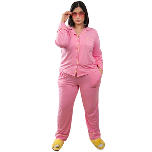 A girl wearing pink long sleeve bamboo pajama set and yellow slippers image 1