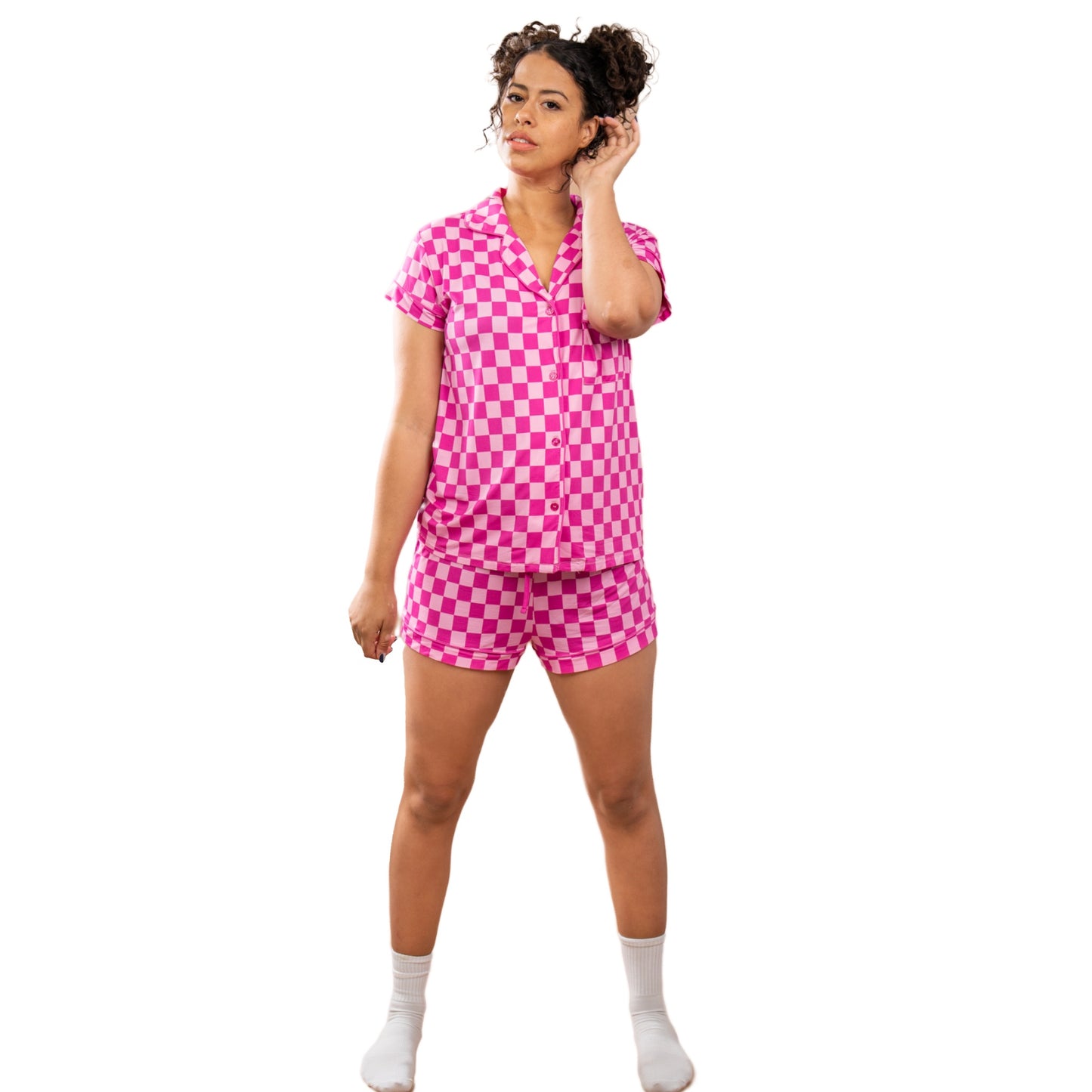 A girl in a pink checkered matching bamboo pajama set - image 1.